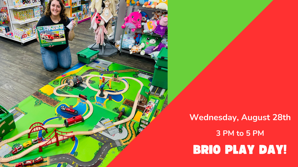 Image of BRIO Play Day announcement and toy train setup with store employee