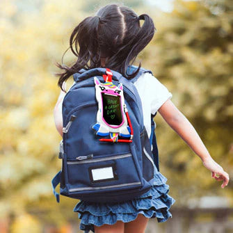 Image of child with Unicorn Boogie Board Sketch Pal attached to her backpack