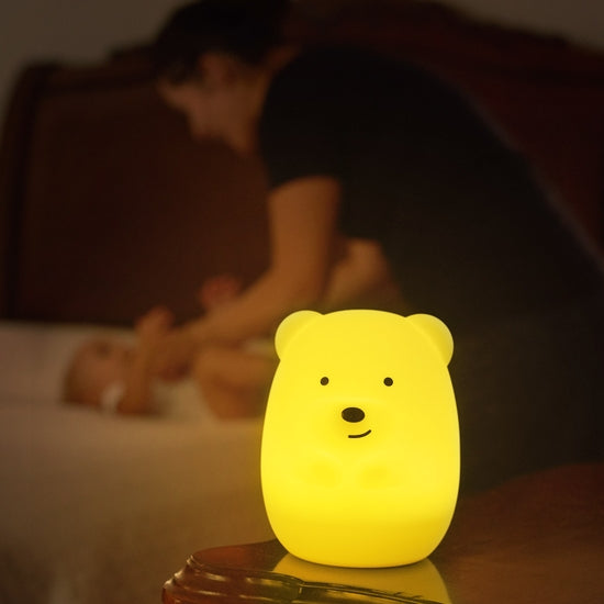 Image of Bear Night Lamp Companion glowing in room with family in the background