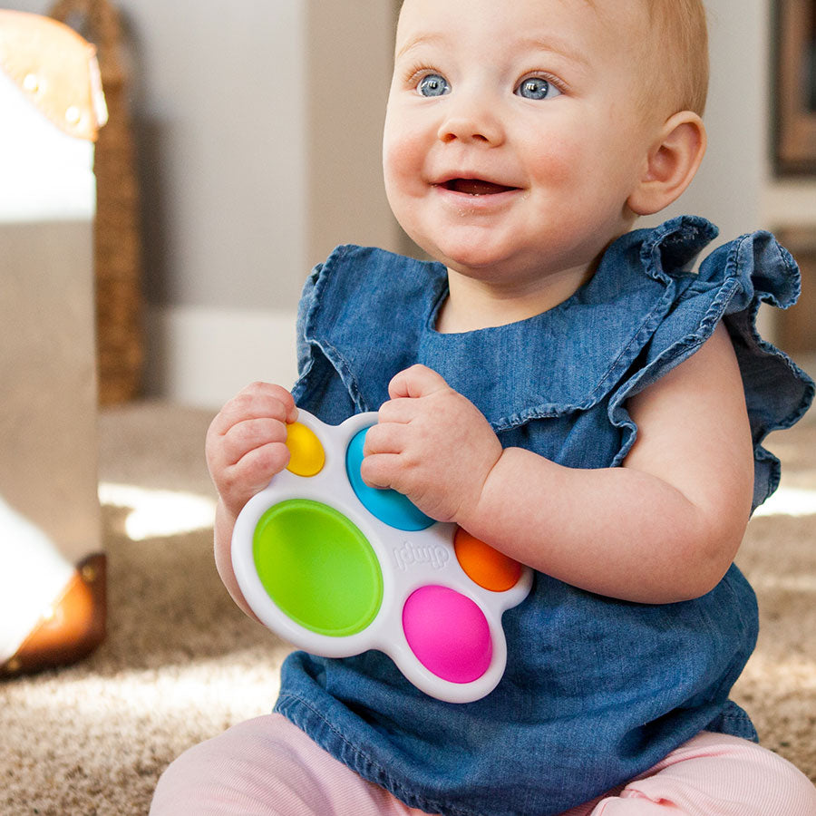 Image of baby holding dimpl baby toy